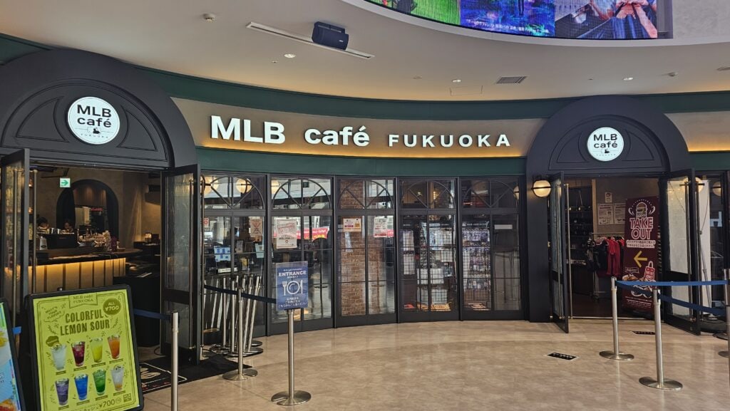 Modern MLB Café entrance in Fukuoka with bright signage and welcoming atmosphere.
