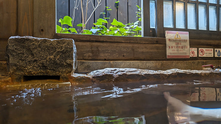 Relaxing hot spring bath at Hyotan Onsen in Beppu, Japan.