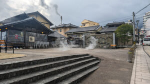 Steam rising from outdoor hot springs in Beppu, Japan.