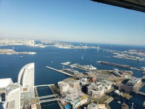 Panoramic view of Yokohama bay and city skyline from a high vantage point.