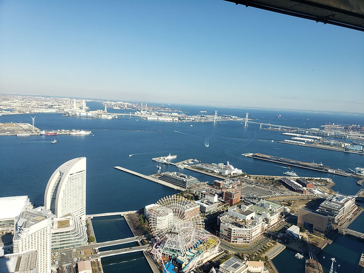 Panoramic view of Yokohama bay and city skyline from a high vantage point.