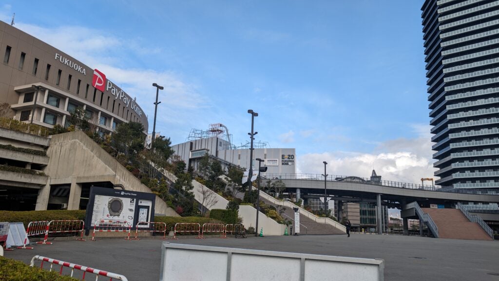 Fukuoka cityscape with modern buildings and transportation infrastructure.