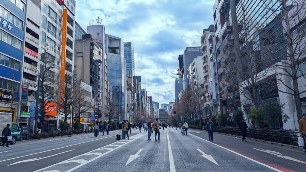 Bustling Tokyo street with skyscrapers and pedestrians.